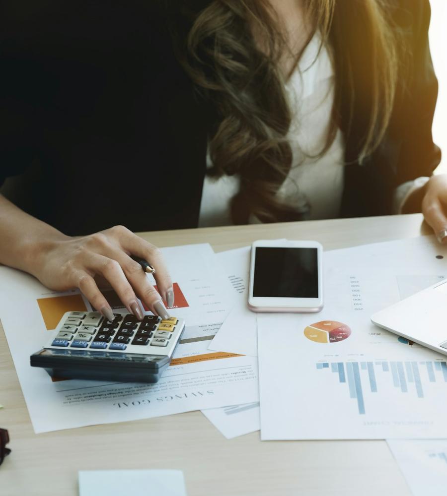 woman using calculator at desk