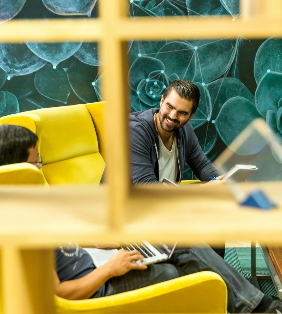 man sitting on yellow couch