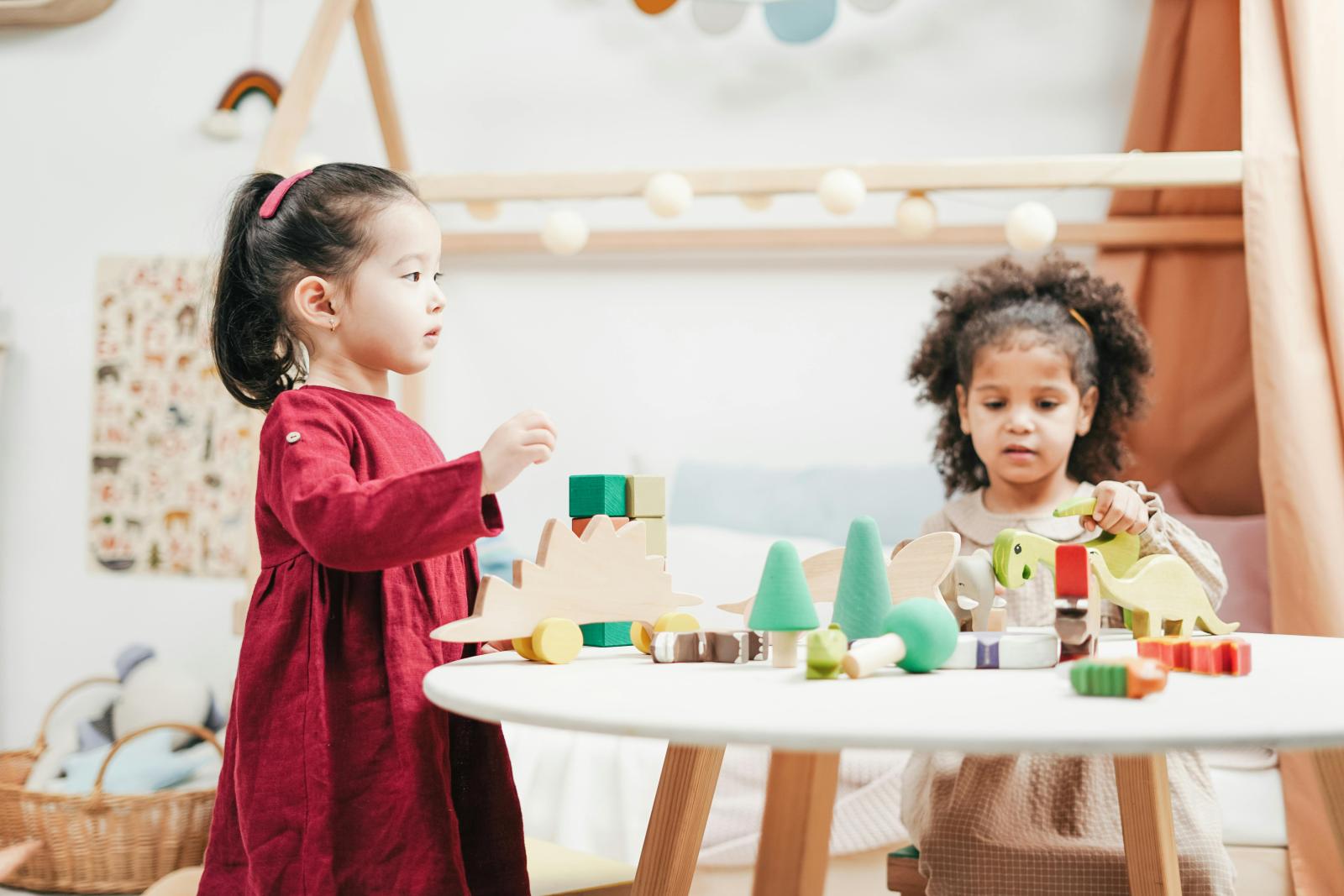 two young girls playing at a table