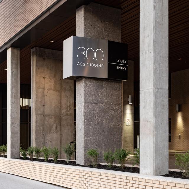 300 Assiniboine. The grand, concrete front entrance to the building as seen from the front sidewalk.